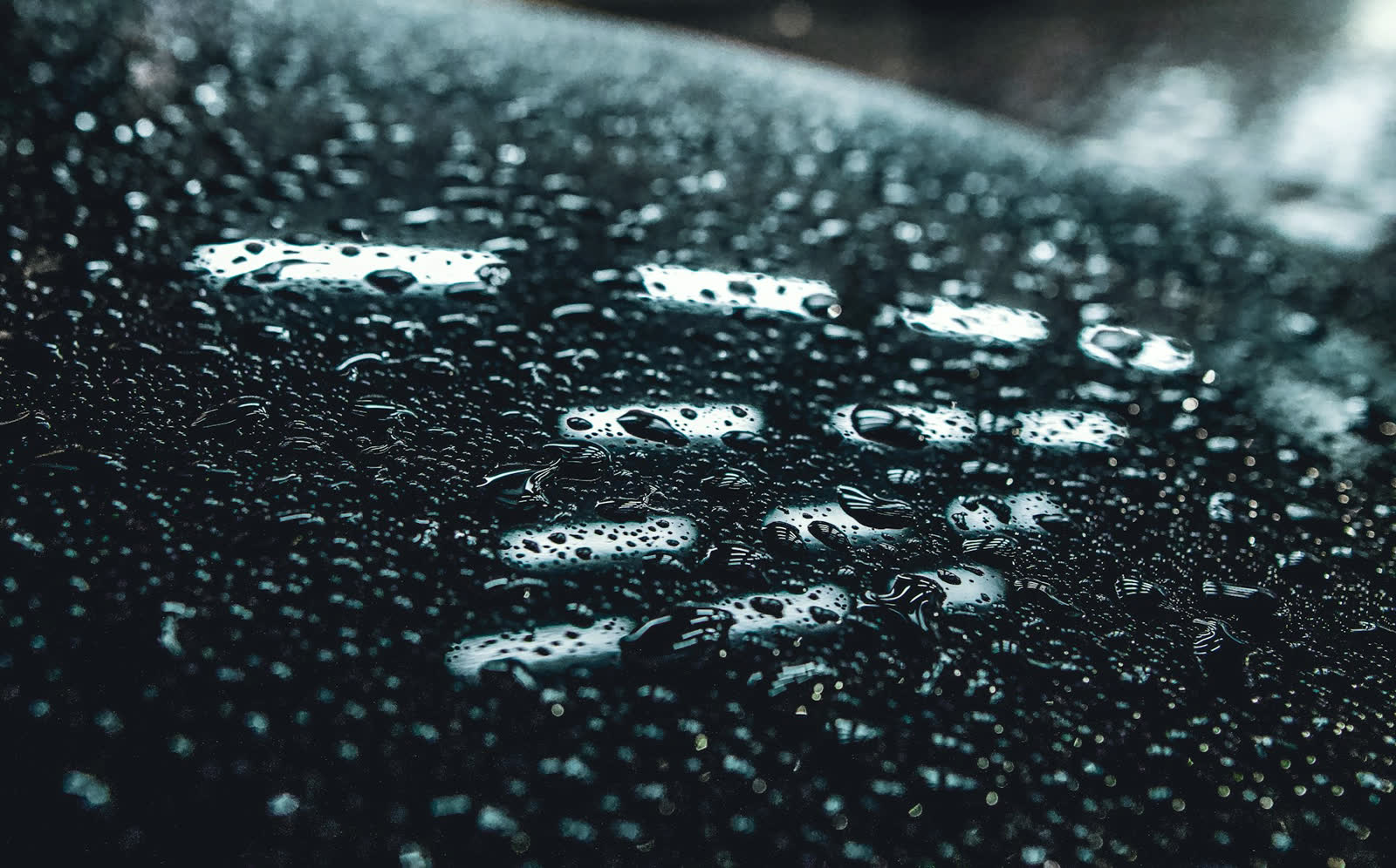 Gotas de água arredondadas sobre pintura preta vitrificada